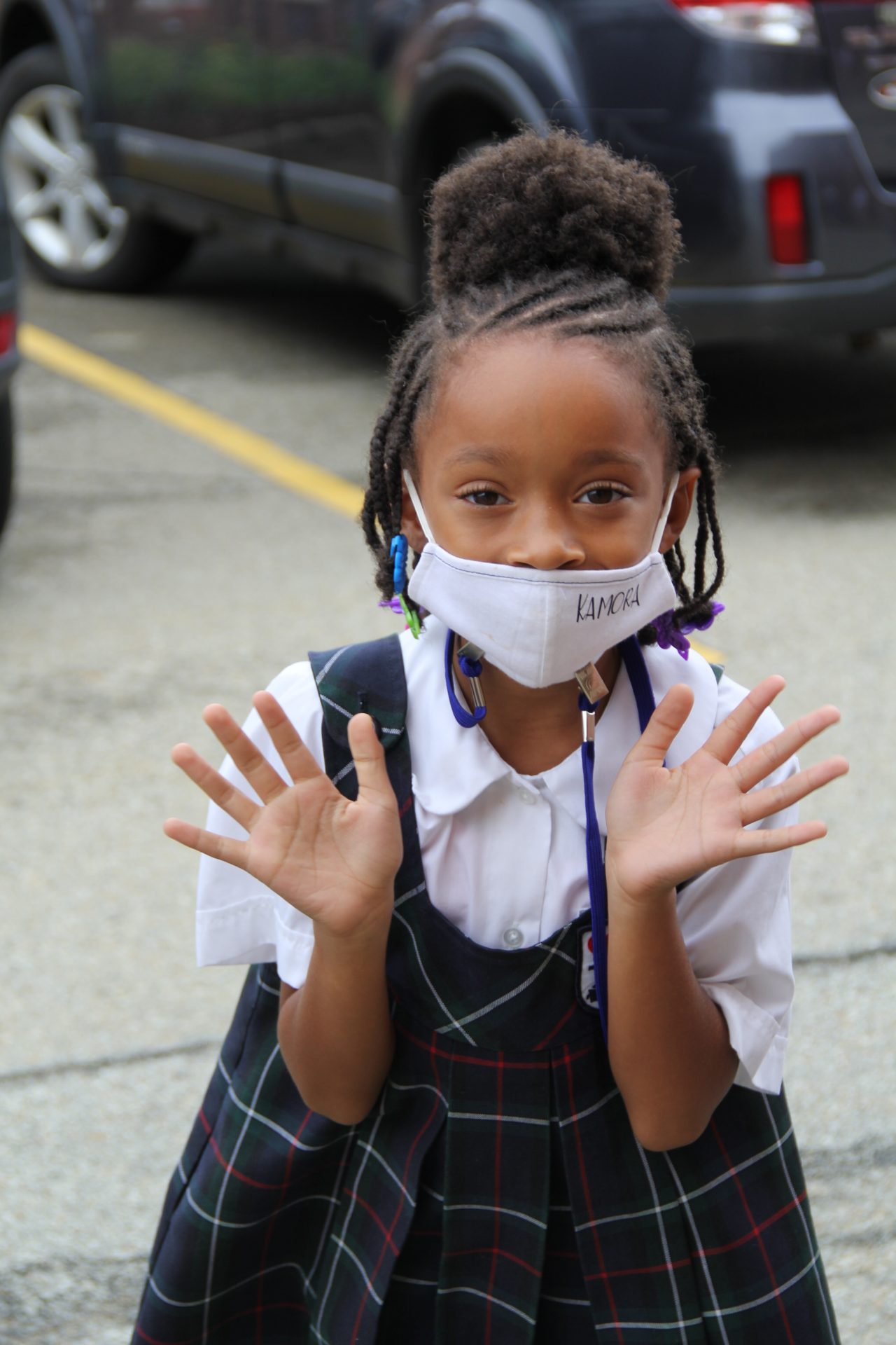 A young Black female student wearing a mask